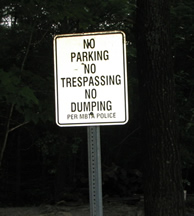 No trespassing sign behind Harbor Village